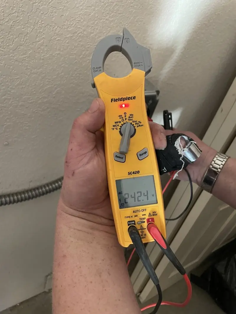 Voltage testing with clamp meter during Recessed Lighting Installation in Bedford